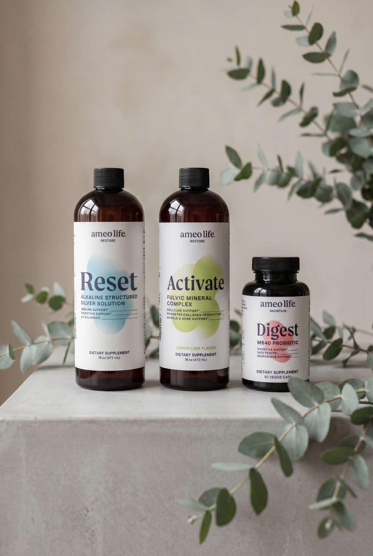 A three-part wellness system arranged on linen with eucalyptus